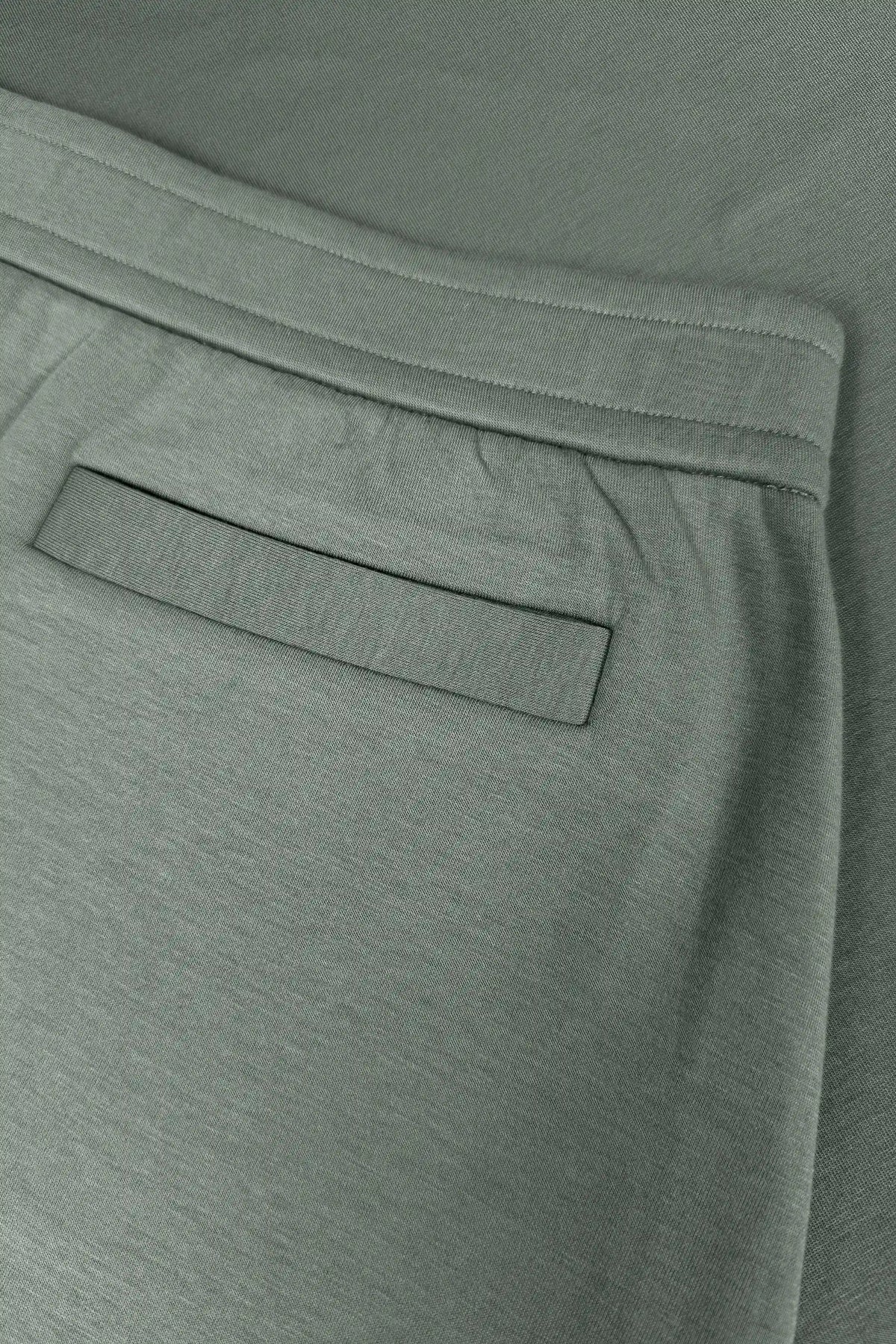 Close-up of women’s sage grey wrap golf skort with waistband and welt back pocket detail