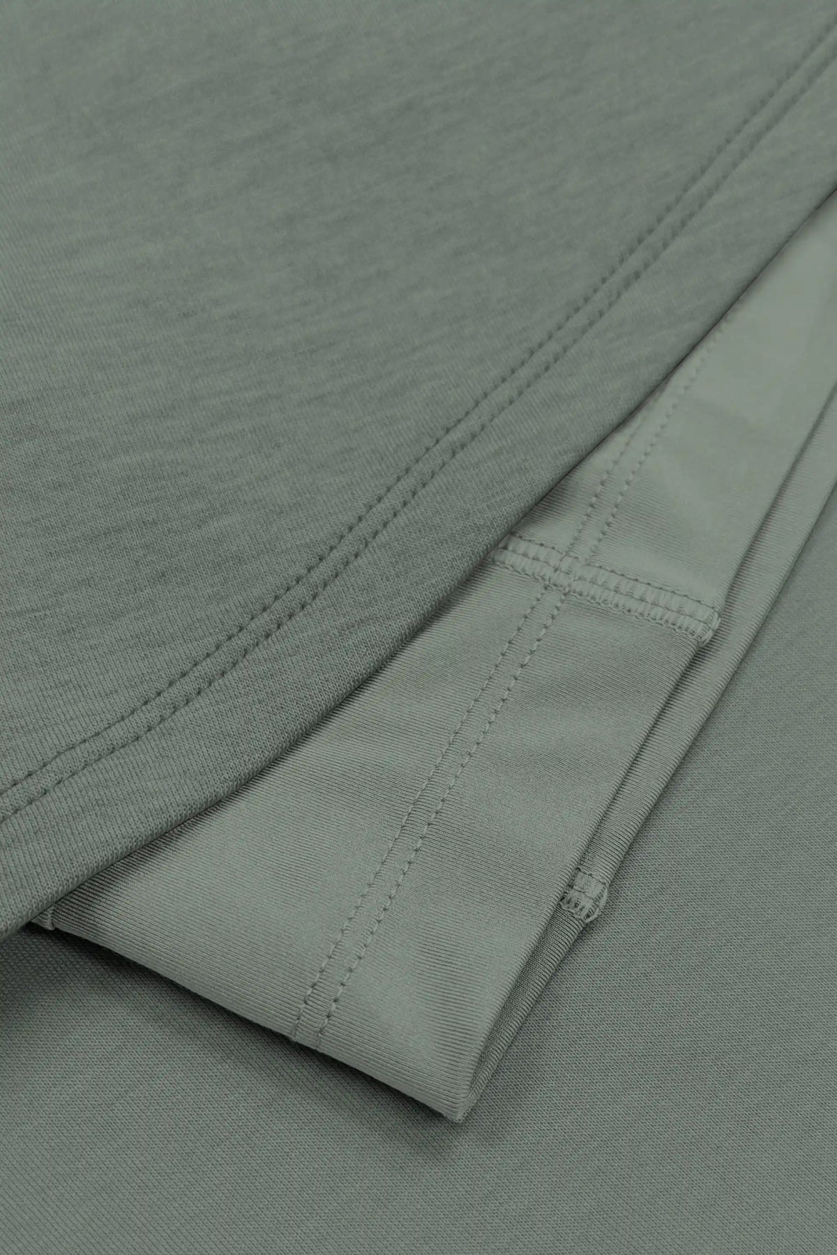 Close-up of the skirt hem stitching and built-in shorts beneath the sage grey wrap golf skort