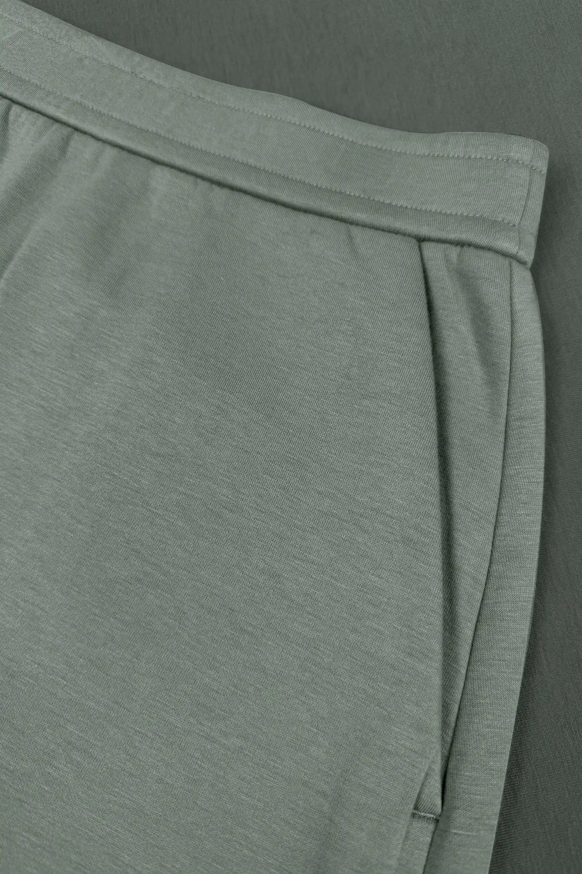 Close-up of women’s sage grey wrap golf skort with structured waistband and side pocket detail