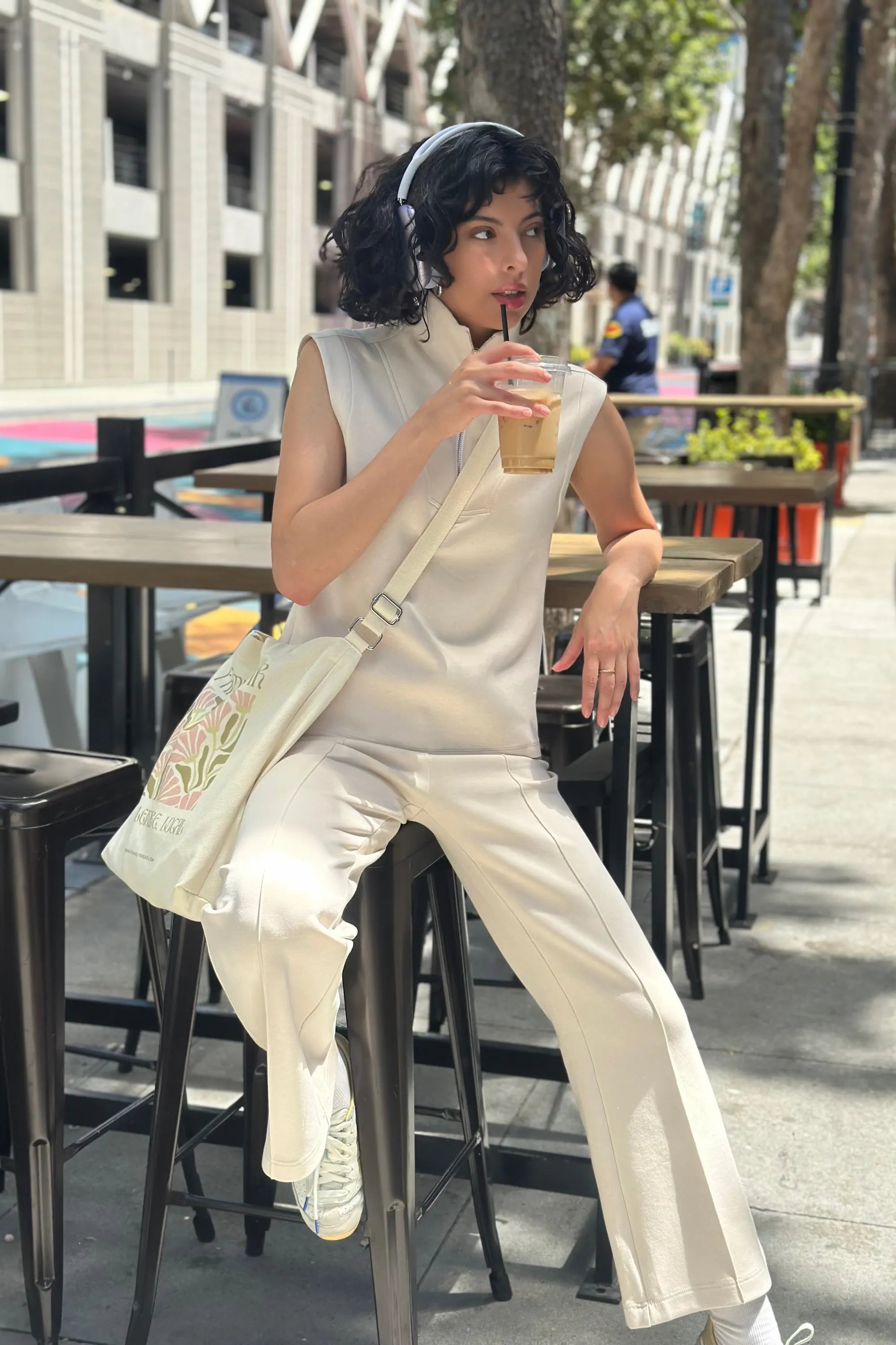 Women’s cream sleeveless pullover styled with relaxed pants for everyday casual wear