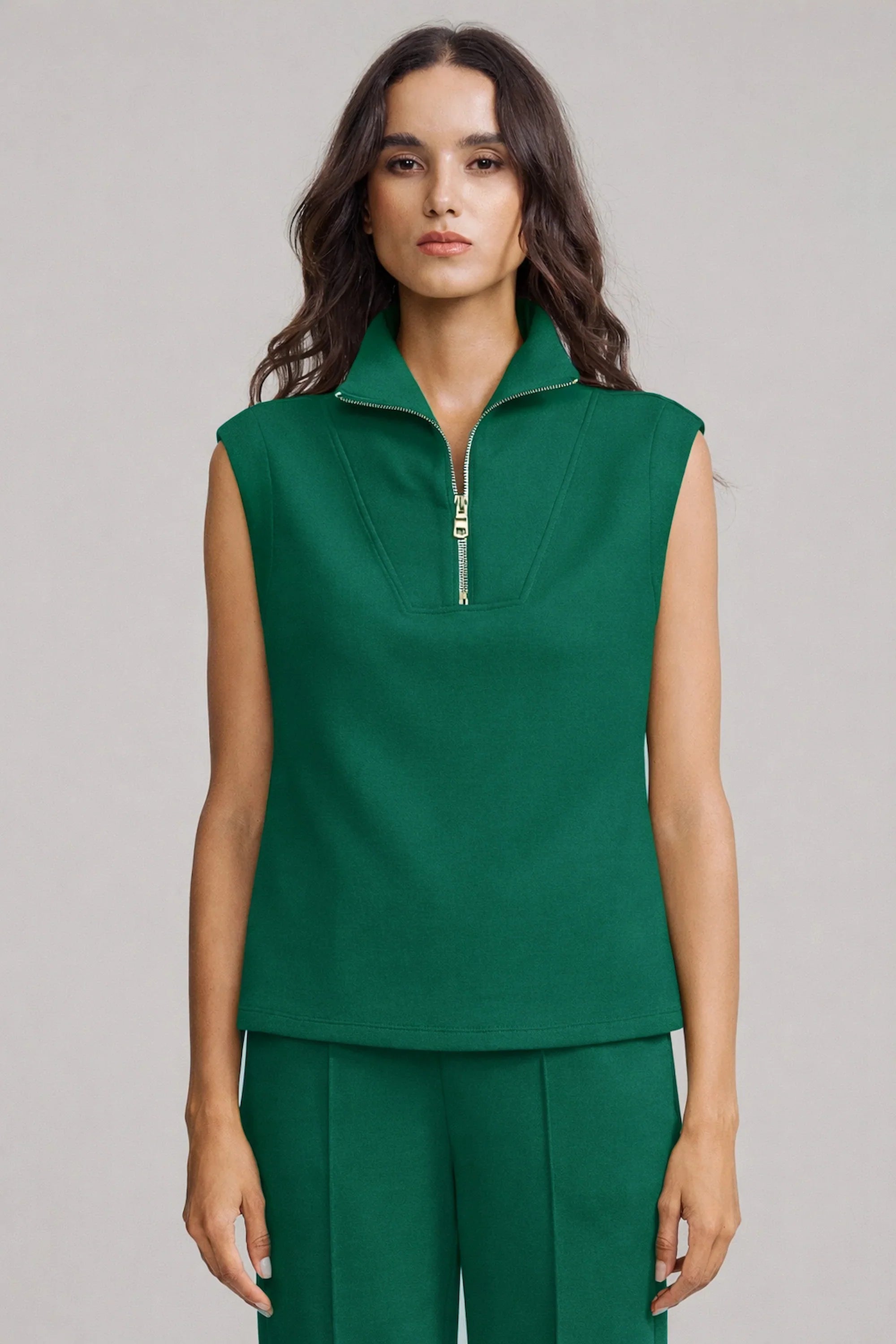 Front view of women’s sleeveless pullover in deep teal with zip neckline