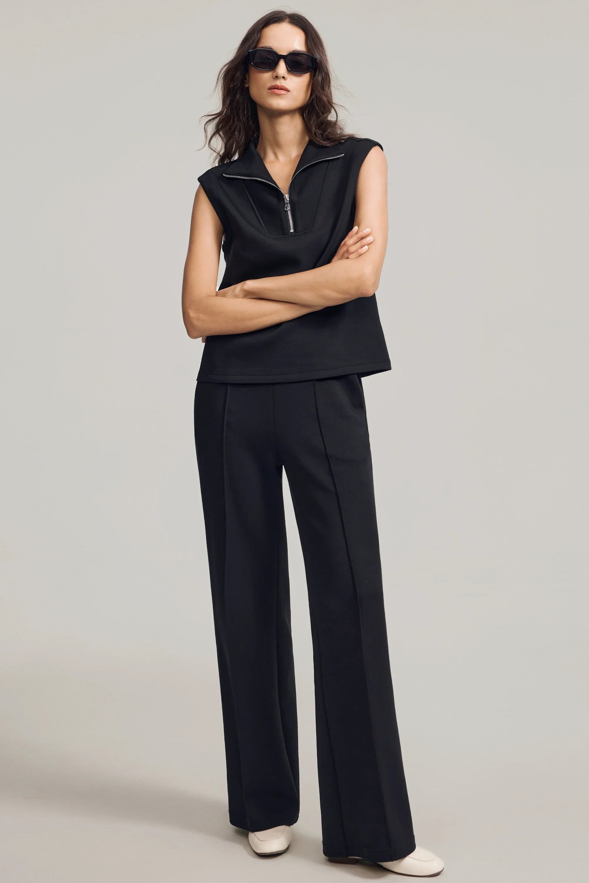 Women’s black sleeveless pullover with structured collar styled for modern everyday wear